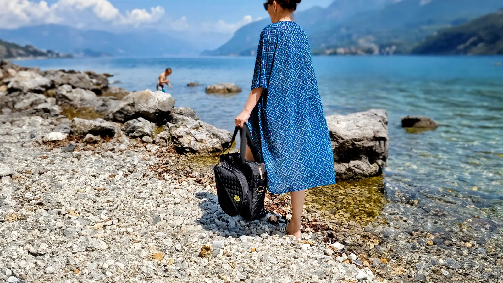 Woman walking by the como lake with a padel tennis bag